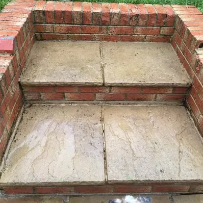 The same stone-topped brick steps after cleaning