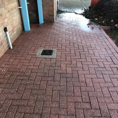 The same commercial passage after cleaning, paving clean and joints clear