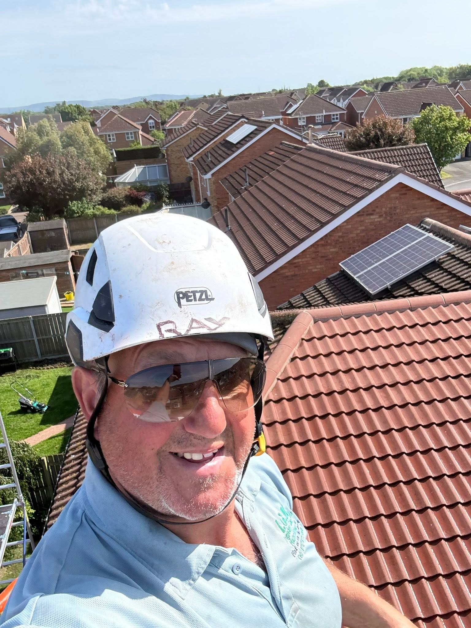 Ray Spashett of IGM Exterior Cleaning in his hard hat on a roof in Teesside